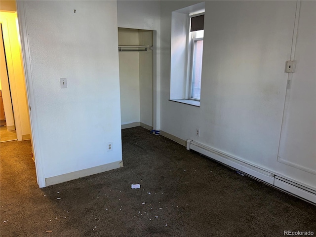 unfurnished bedroom featuring a baseboard radiator, a closet, and baseboards