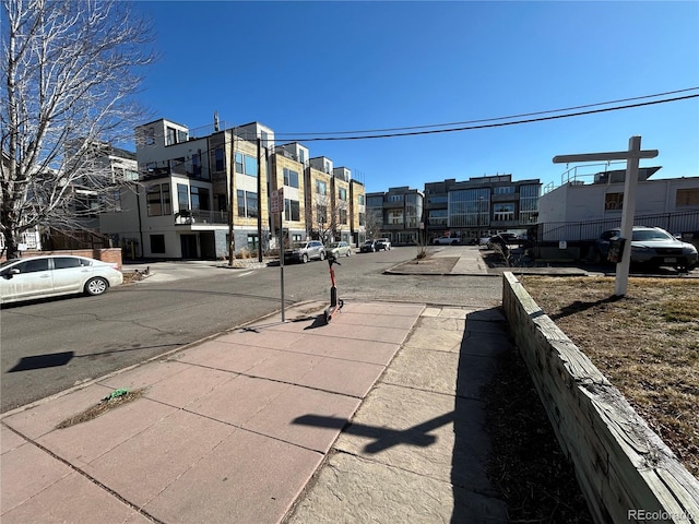 view of road featuring sidewalks, a residential view, and curbs