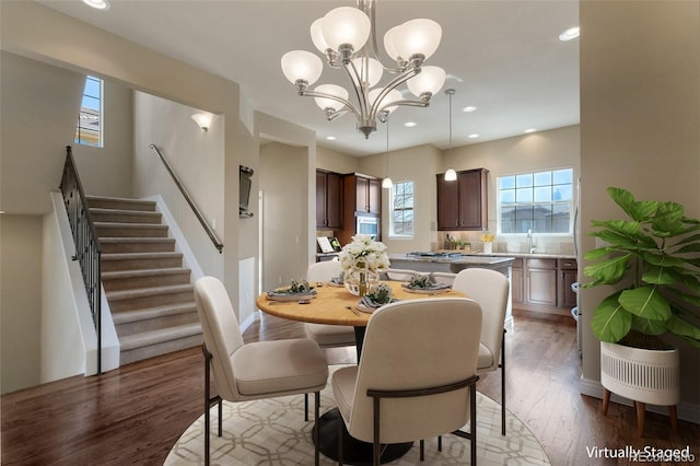 dining space with a notable chandelier, stairway, recessed lighting, and wood finished floors