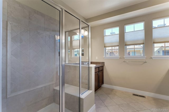 full bath with visible vents, a shower stall, vanity, and plenty of natural light