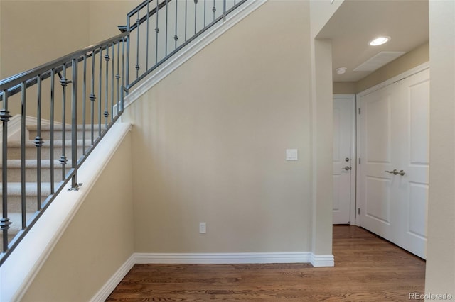 stairs with recessed lighting, baseboards, and wood finished floors