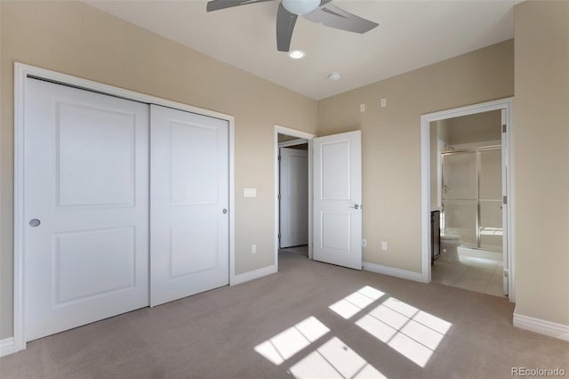 unfurnished bedroom with baseboards, a closet, and light carpet