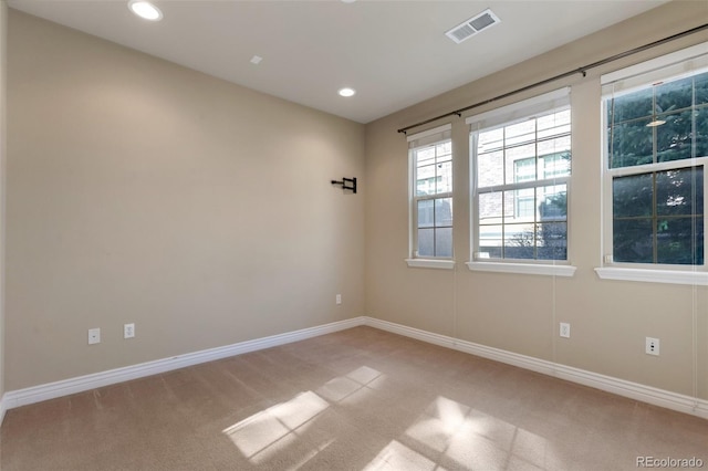 spare room featuring visible vents, recessed lighting, baseboards, and carpet floors