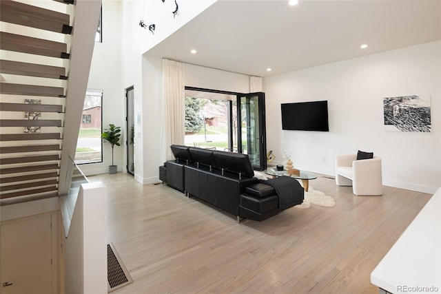 62 Jasmine St, Denver, CO 80220 - living room with light wood-style flooring, stairs, recessed lighting, and baseboards