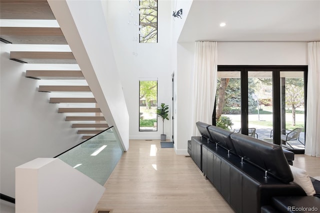 62 Jasmine St, Denver, CO 80220 - foyer entrance with healthy amount of natural light, stairs, recessed lighting, light wood-style floors, and baseboards