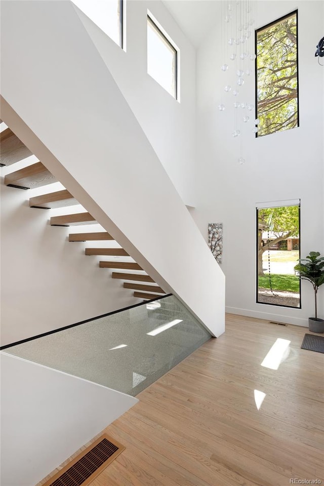 62 Jasmine St, Denver, CO 80220 - stairway with a high ceiling, wood finished floors, healthy amount of natural light, and baseboards