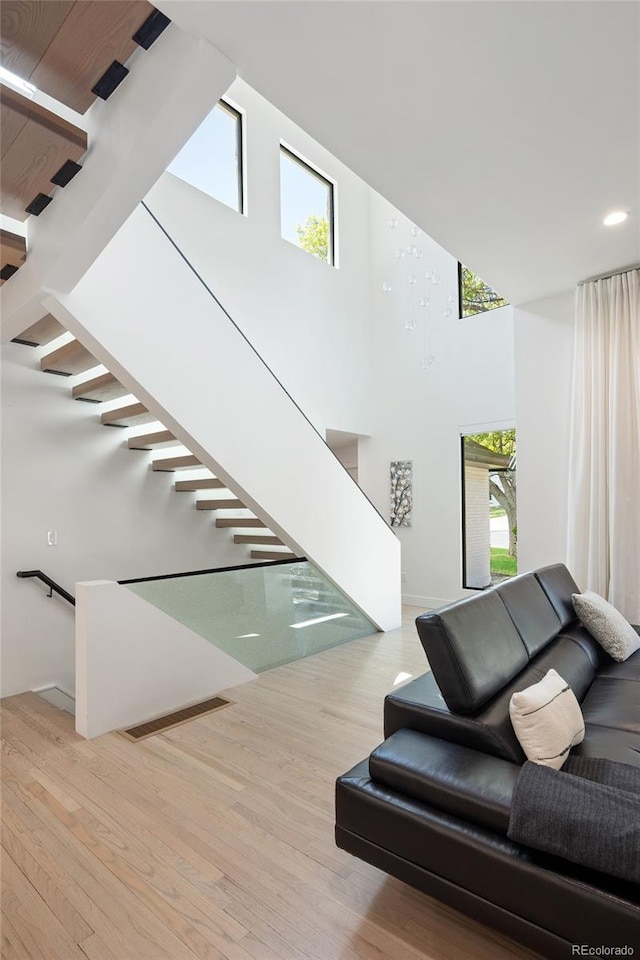 62 Jasmine St, Denver, CO 80220 - staircase with a high ceiling, plenty of natural light, wood finished floors, and recessed lighting