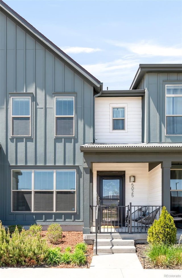 5025 Central Park Blvd, Denver, CO 80238 - view of property with board and batten siding and a porch