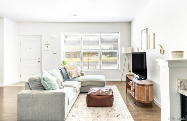 5025 Central Park Blvd, Denver, CO 80238 - living room featuring a fireplace, wood finished floors, baseboards, and recessed lighting