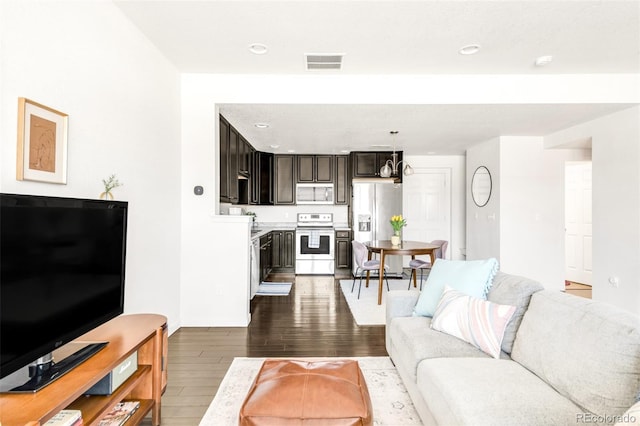 5025 Central Park Blvd, Denver, CO 80238 - living area featuring dark wood-style flooring, recessed lighting, and baseboards