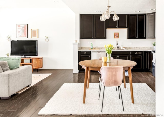 5025 Central Park Blvd, Denver, CO 80238 - kitchen featuring a sink, dark wood finished floors, light countertops, baseboards, and hanging light fixtures