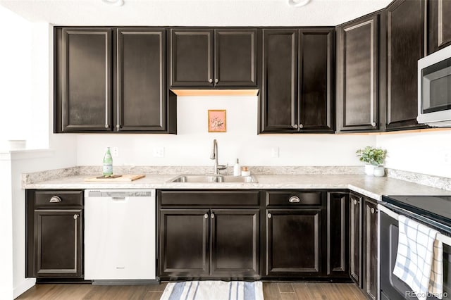 5025 Central Park Blvd, Denver, CO 80238 - kitchen with appliances with stainless steel finishes, a sink, light wood-type flooring, and dark brown cabinetry