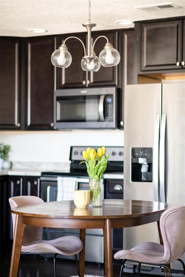 5025 Central Park Blvd, Denver, CO 80238 - kitchen featuring stainless steel appliances, dark brown cabinets, a textured ceiling, and light countertops