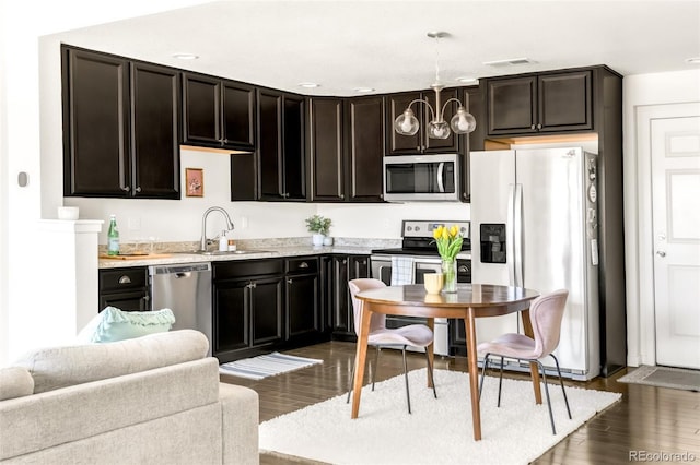 5025 Central Park Blvd, Denver, CO 80238 - kitchen featuring stainless steel appliances, a sink, dark wood-type flooring, and light countertops
