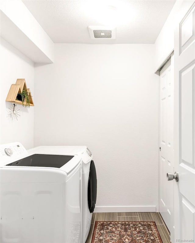 5025 Central Park Blvd, Denver, CO 80238 - washroom featuring washing machine and clothes dryer, wood finished floors, and baseboards