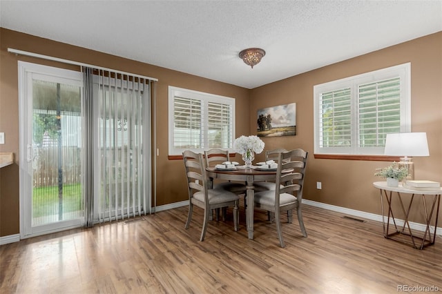 6119 Zenobia Ct, Arvada, CO 80003 - dining space featuring wood finished floors and healthy amount of natural light