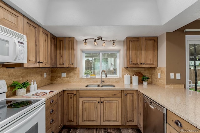6119 Zenobia Ct, Arvada, CO 80003 - kitchen with white appliances, backsplash, brown cabinetry, and light stone countertops