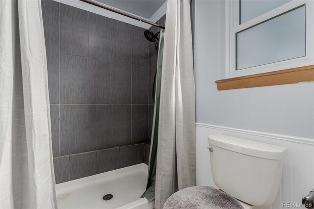 6119 Zenobia Ct, Arvada, CO 80003 - full bathroom with a stall shower and a wainscoted wall