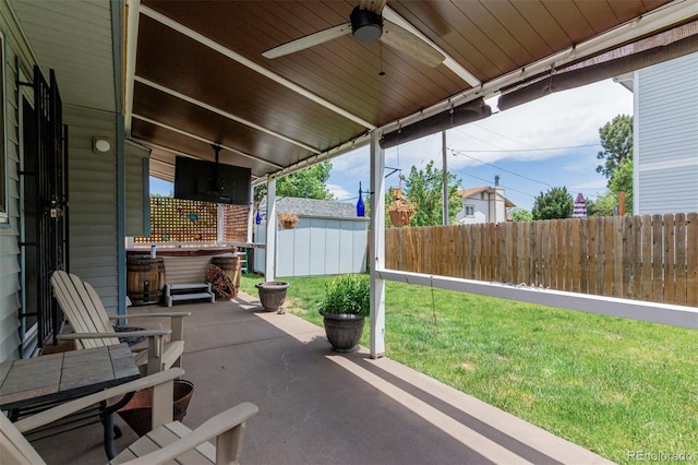 6119 Zenobia Ct, Arvada, CO 80003 - fenced backyard with a hot tub, a patio, and ceiling fan