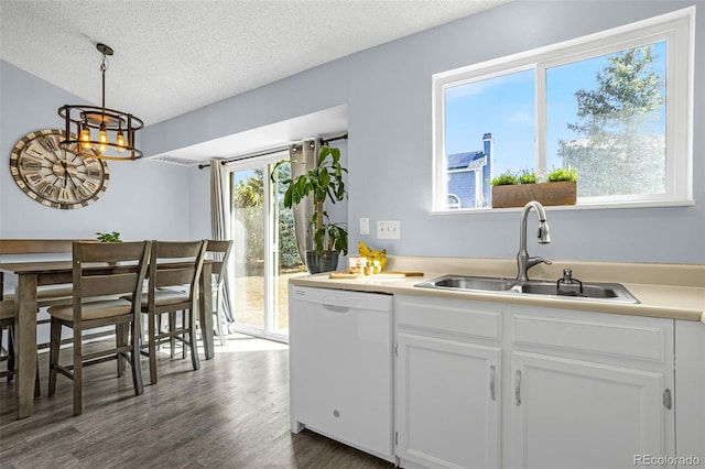 kitchen featuring dark wood finished floors, dishwasher, white cabinets, a textured ceiling, and a sink