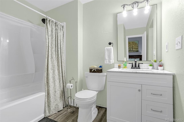 bathroom featuring vanity, toilet, wood finished floors, and shower / tub combo with curtain