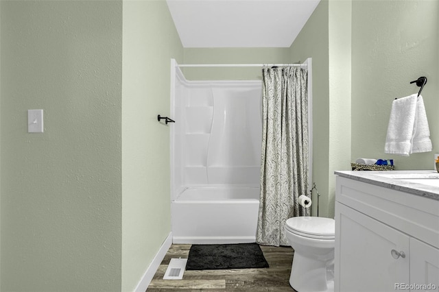 bathroom featuring visible vents, toilet, shower / bath combo, wood finished floors, and vanity