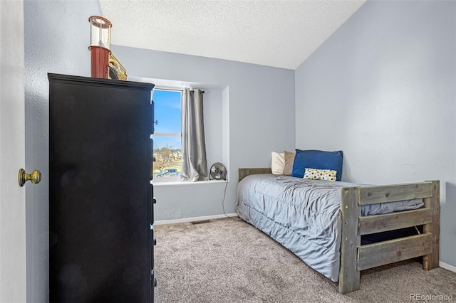 carpeted bedroom featuring visible vents, baseboards, and a textured ceiling