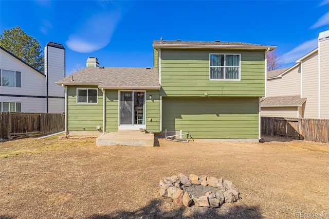 rear view of property featuring a fenced backyard and a patio area