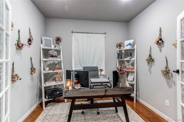 home office with hardwood / wood-style flooring