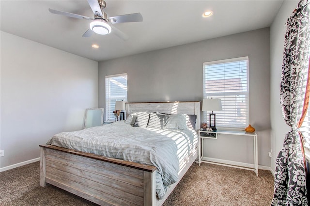 carpeted bedroom with multiple windows and ceiling fan