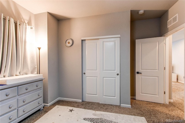 unfurnished bedroom featuring carpet floors and a closet