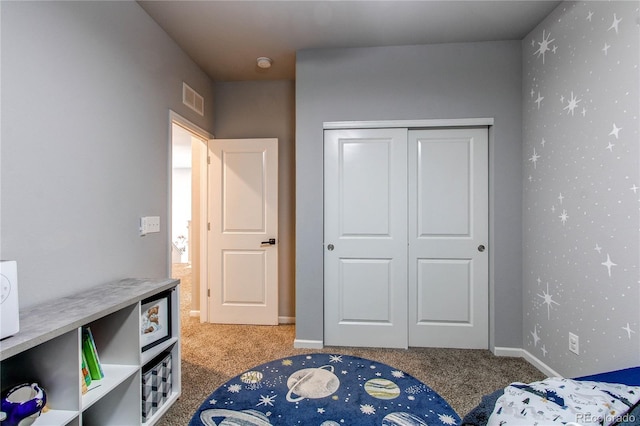 carpeted bedroom featuring a closet