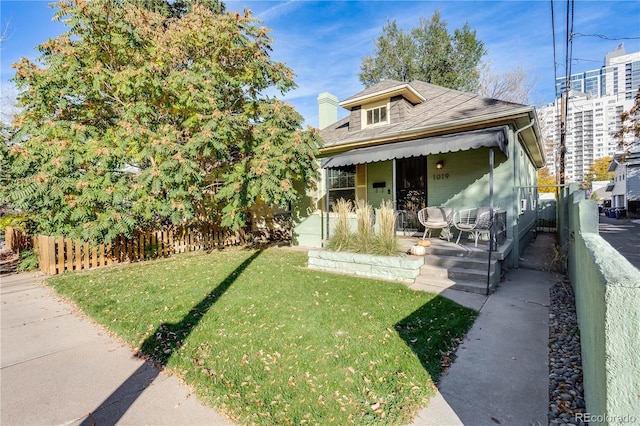 view of front of house with a front yard and a porch