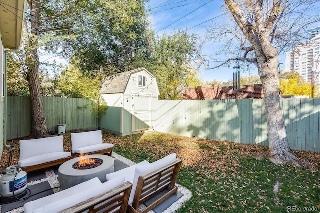 view of yard with a shed and a fire pit