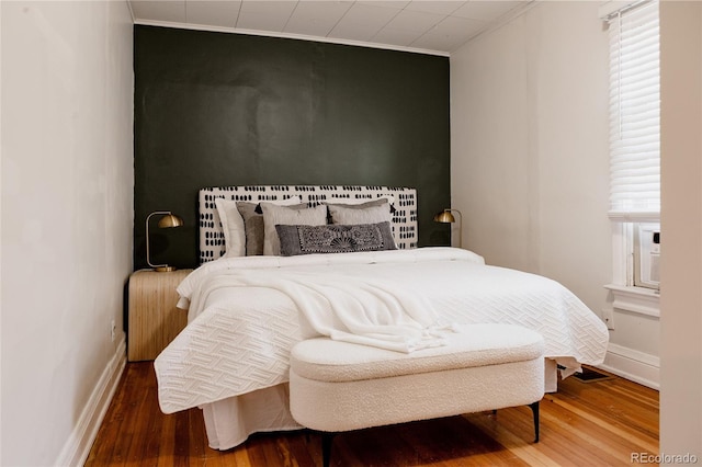 bedroom featuring hardwood / wood-style flooring and ornamental molding