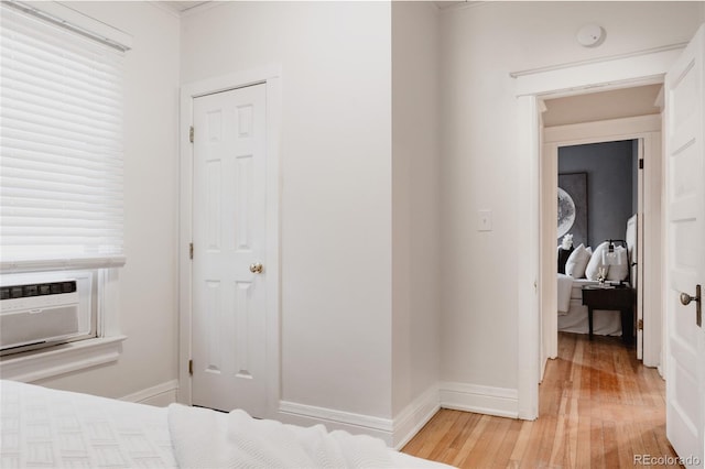 bedroom featuring hardwood / wood-style floors and cooling unit