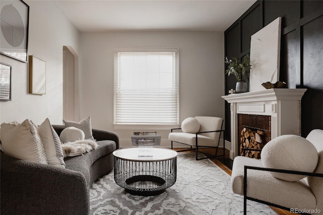 sitting room featuring hardwood / wood-style floors and a high end fireplace