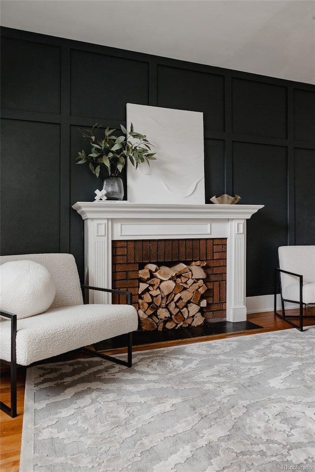 sitting room featuring a fireplace and light hardwood / wood-style floors