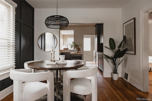 dining space with dark wood-type flooring