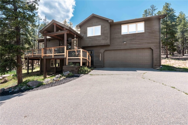 32663 Donna Dr, Conifer, CO 80433 - view of front of property with an attached garage, driveway, and a deck