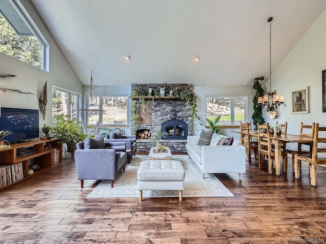 32663 Donna Dr, Conifer, CO 80433 - living area featuring high vaulted ceiling, wood finished floors, a chandelier, recessed lighting, and a fireplace
