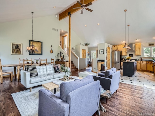 32663 Donna Dr, Conifer, CO 80433 - living room with beam ceiling, ceiling fan, high vaulted ceiling, stairway, and light wood-style flooring