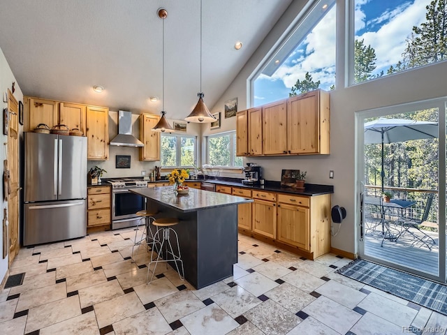32663 Donna Dr, Conifer, CO 80433 - kitchen with appliances with stainless steel finishes, wall chimney exhaust hood, dark countertops, a breakfast bar area, and high vaulted ceiling