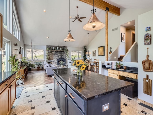 32663 Donna Dr, Conifer, CO 80433 - kitchen featuring high vaulted ceiling, a ceiling fan, healthy amount of natural light, a kitchen island, and beam ceiling