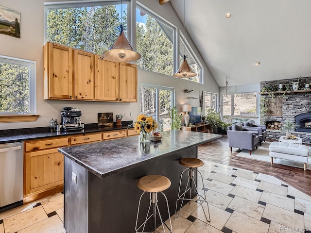 32663 Donna Dr, Conifer, CO 80433 - kitchen featuring stainless steel dishwasher, high vaulted ceiling, a kitchen breakfast bar, open floor plan, and a kitchen island