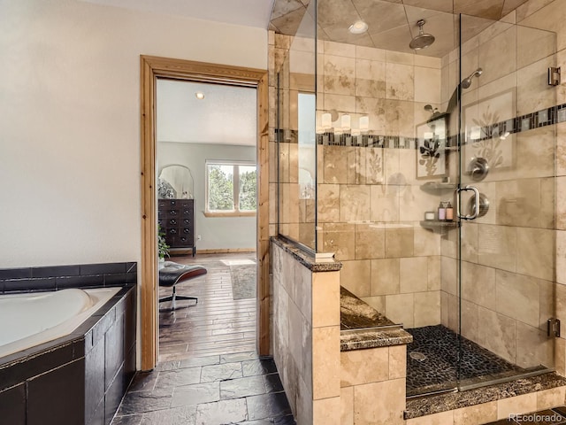 32663 Donna Dr, Conifer, CO 80433 - full bath with a stall shower, a garden tub, and stone tile floors