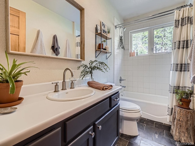 32663 Donna Dr, Conifer, CO 80433 - full bath with vanity, shower / bath combination with curtain, a textured wall, and stone tile flooring