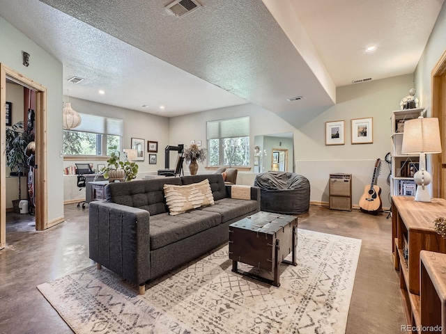 32663 Donna Dr, Conifer, CO 80433 - living area featuring concrete flooring, a textured ceiling, and recessed lighting