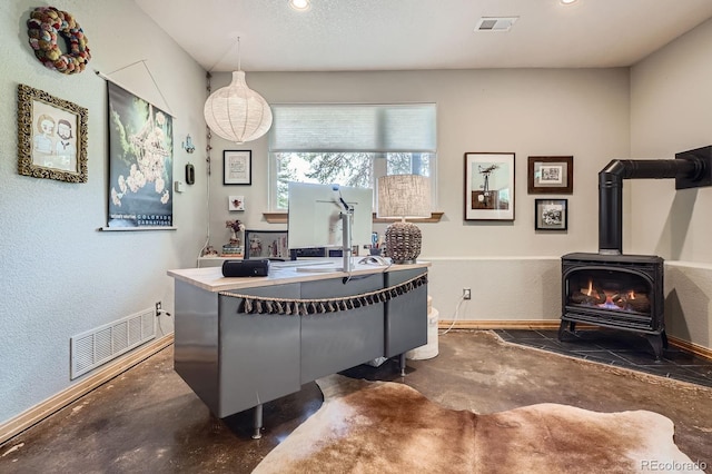 32663 Donna Dr, Conifer, CO 80433 - office area with concrete floors, a wood stove, and recessed lighting