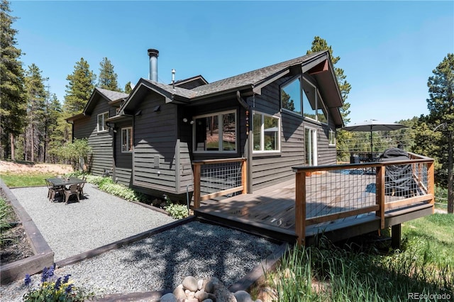 32663 Donna Dr, Conifer, CO 80433 - rear view of house with a deck, a patio area, and outdoor dining space